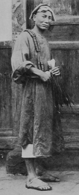 Photograph of a man carrying cash coins during the Qing Dynasty