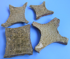 Clay versions of State of Chu gold plate money (泥"郢称"(楚国黄金货币)) found buried in tombs of the Warring States Period