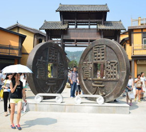 Large sculptures of 'Kai Yuan Tong Bao' coins at entrance to the exhibition