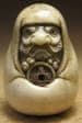 Bodhidharma holding a wu zhu
          coin