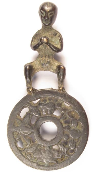 Chinese charm with boy standing on top